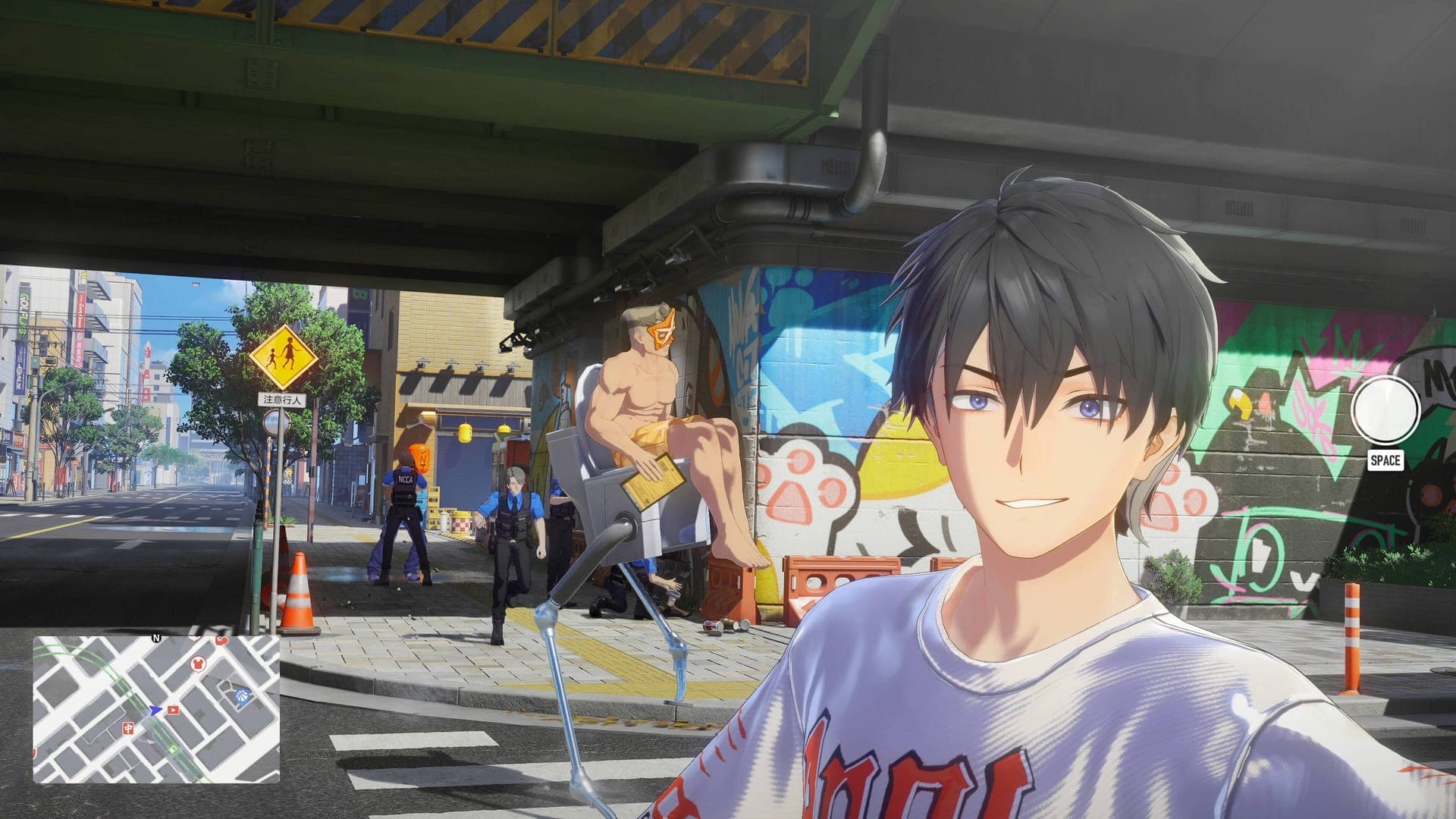 The Captain takes a selfie under an overpass covered in graffiti while a man in sunglasses poses behind him
