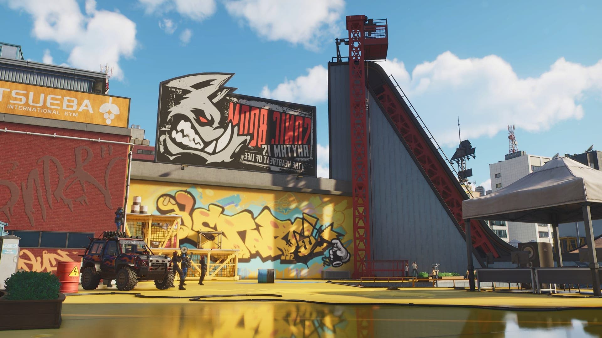 An industrial yard in the Veluxity Zone with a boar graffiti logo on a wall, a conveyor tower and parked off-road vehicles